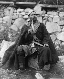 Old peasant with dagger and long smoking pipe, Saradia.jpg