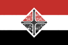 The red-white-black triband contoured around a diamond-shape comprised of the words "National Renovation Front" repeated 22 times in kufic script in black.