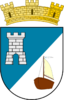 Shield divided diagonally, the upper left with a white castle on a blue field, the bottom right with a lateen-sailed boat over a white field, beneath a mural crown