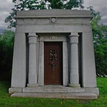 Photograph of a stone mausoleum with the word "ROSSLYN" engraved on its top