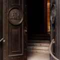 A view of the hotel's decorative main doors, embossed with the Bellême family seal.