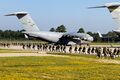 Multiple paratroopers getting in a MAC-54K to start training exercises